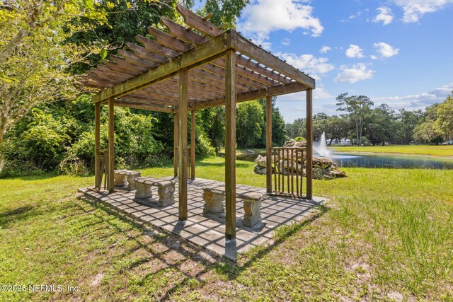 166 Mount Royal Ave, Crescent City, FL 32112 - view of green lawn featuring a water view, a pergola, a patio, and view of wooded area