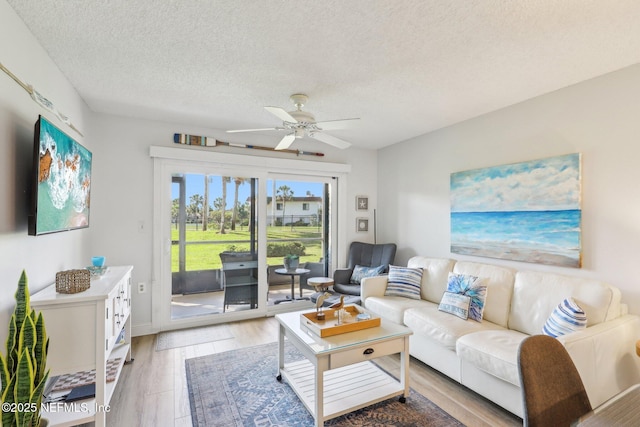 4250 A1A S Unit C15, Saint Augustine, FL 32080 - living area featuring a ceiling fan, a textured ceiling, and light wood-type flooring
