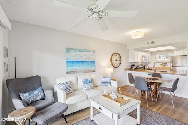 4250 A1A S Unit C15, Saint Augustine, FL 32080 - living room with light wood-type flooring, ceiling fan, and baseboards