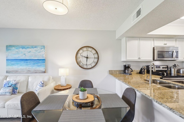 4250 A1A S Unit C15, Saint Augustine, FL 32080 - dining space featuring a textured ceiling