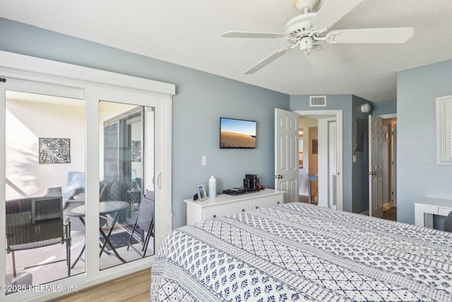 4250 A1A S Unit C15, Saint Augustine, FL 32080 - bedroom with light wood-style floors, a textured ceiling, access to outside, and a ceiling fan