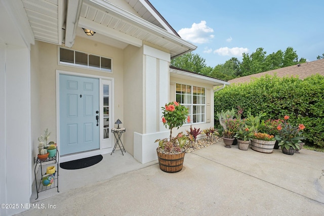 1494 Cedar Grove Ter, Fleming Island, FL 32003 - doorway to property featuring a patio and stucco siding