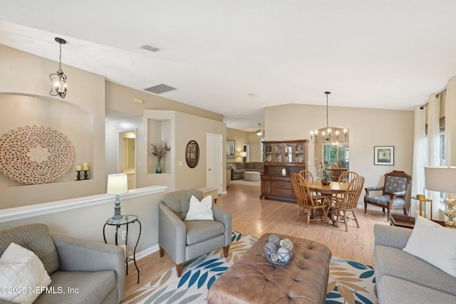 1494 Cedar Grove Ter, Fleming Island, FL 32003 - living area with a chandelier, light wood-type flooring, vaulted ceiling, and baseboards