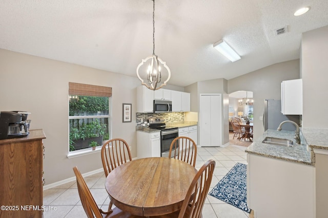 1494 Cedar Grove Ter, Fleming Island, FL 32003 - dining area with a chandelier, light tile patterned flooring, lofted ceiling, and a textured ceiling