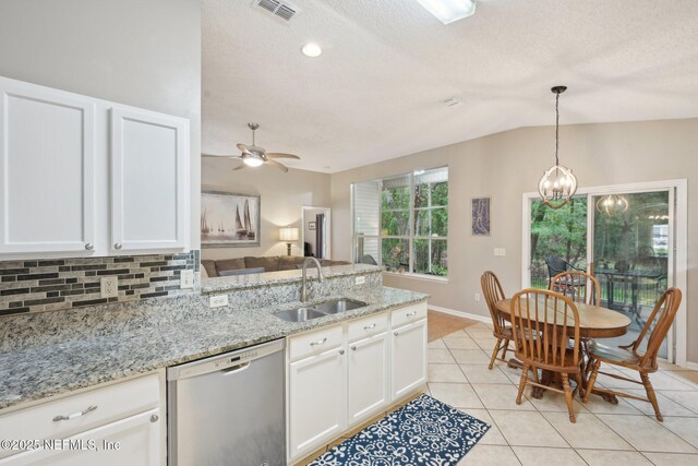 1494 Cedar Grove Ter, Fleming Island, FL 32003 - kitchen with dishwasher, a sink, a peninsula, decorative backsplash, and light tile patterned floors
