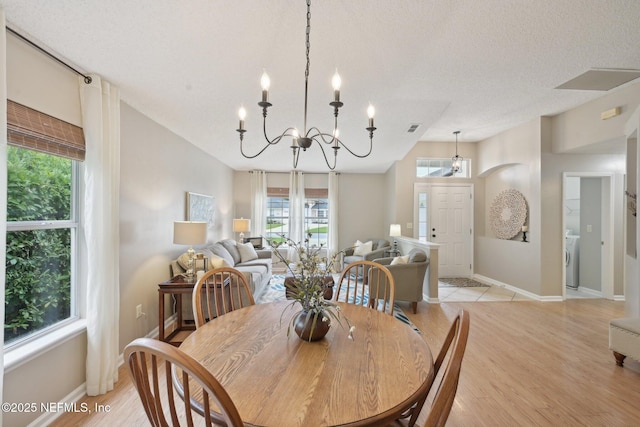 1494 Cedar Grove Ter, Fleming Island, FL 32003 - dining area featuring a chandelier, plenty of natural light, light wood-style floors, and baseboards