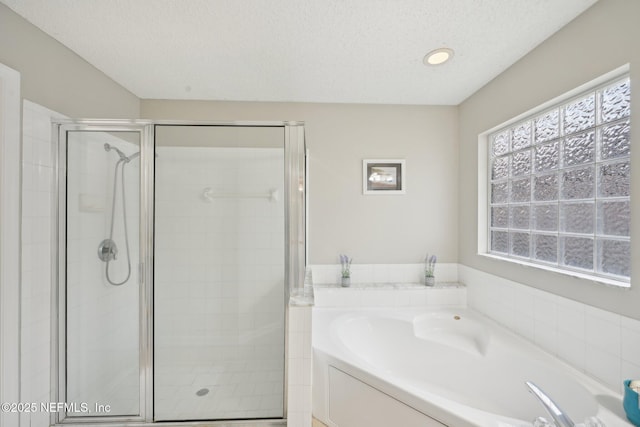 1494 Cedar Grove Ter, Fleming Island, FL 32003 - full bathroom with a garden tub, a stall shower, recessed lighting, and a textured ceiling