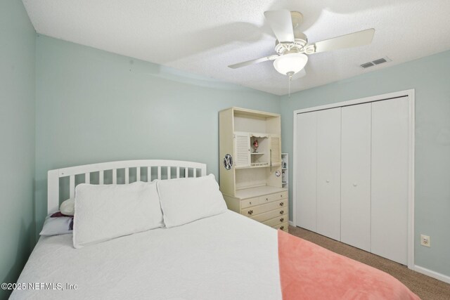 1494 Cedar Grove Ter, Fleming Island, FL 32003 - carpeted bedroom featuring a closet, ceiling fan, and a textured ceiling