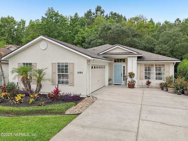 1494 Cedar Grove Ter, Fleming Island, FL 32003 - ranch-style home with an attached garage, driveway, stucco siding, and a shingled roof