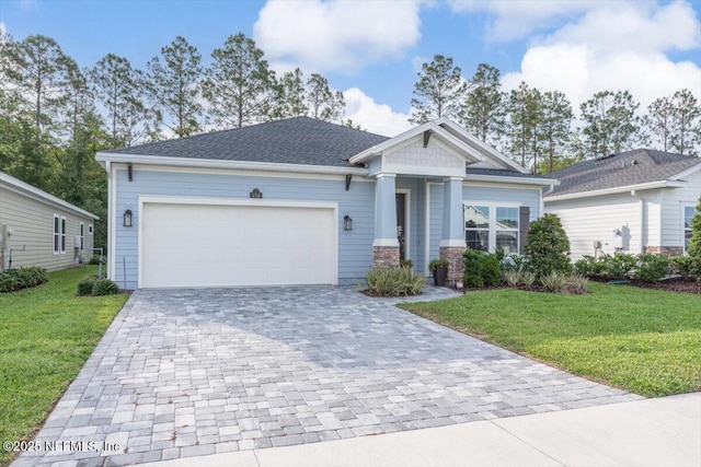 710 Stillwater Blvd, Saint Johns, FL 32259 - craftsman house with decorative driveway, a front lawn, an attached garage, and stone siding