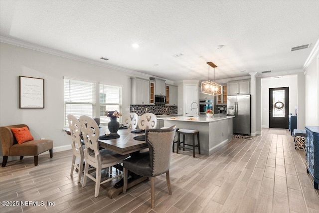 710 Stillwater Blvd, Saint Johns, FL 32259 - dining space featuring light wood-style floors, crown molding, and baseboards