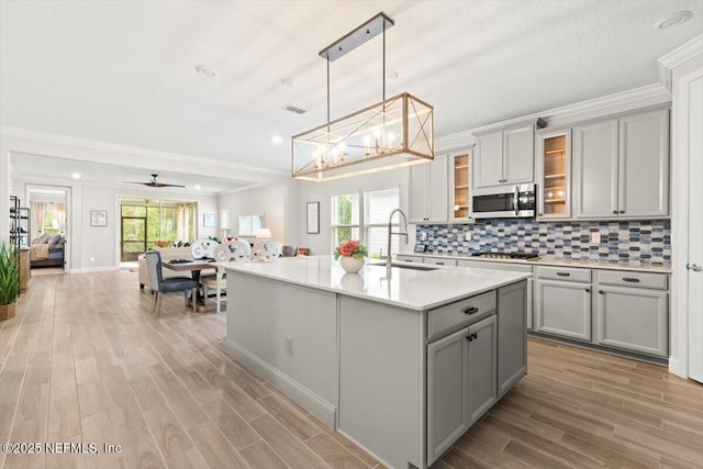 710 Stillwater Blvd, Saint Johns, FL 32259 - kitchen featuring gray cabinets, appliances with stainless steel finishes, a sink, light wood-style flooring, and light countertops