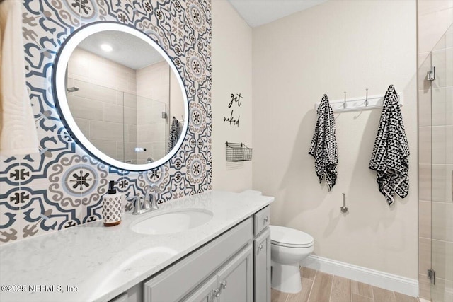 710 Stillwater Blvd, Saint Johns, FL 32259 - bathroom featuring vanity, a tile shower, baseboards, toilet, and wood finished floors