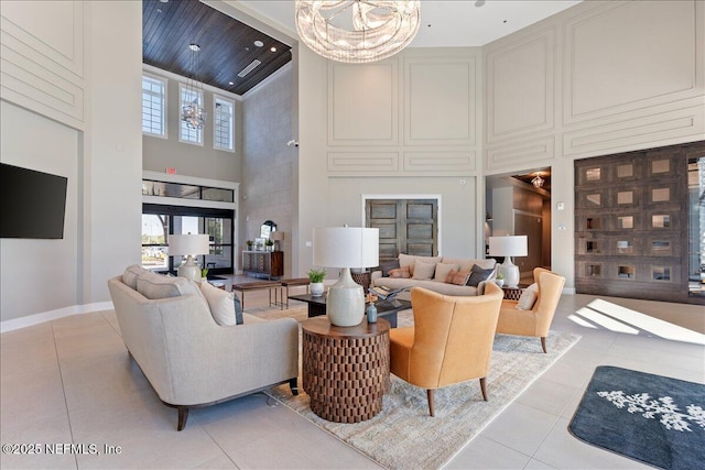 710 Stillwater Blvd, Saint Johns, FL 32259 - living area with a towering ceiling, light tile patterned floors, a chandelier, and baseboards