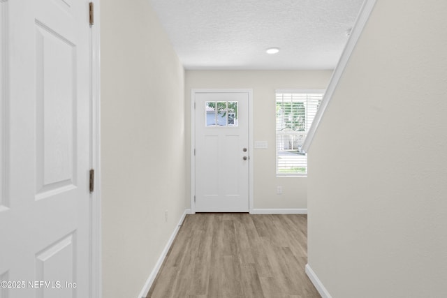 8198 Dandy Ave, Jacksonville, FL 32211 - entrance foyer featuring baseboards, a textured ceiling, and light wood-type flooring