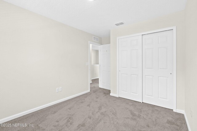 8198 Dandy Ave, Jacksonville, FL 32211 - unfurnished bedroom featuring carpet floors, baseboards, and a closet