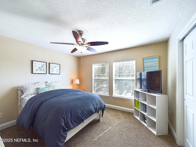 85667 Berryessa Way, Fernandina Beach, FL 32034 - carpeted bedroom featuring baseboards, a textured ceiling, and ceiling fan