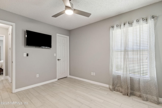 1254 Palisades Dr, Jacksonville, FL 32221 - unfurnished bedroom with light wood-type flooring, a textured ceiling, baseboards, and ceiling fan