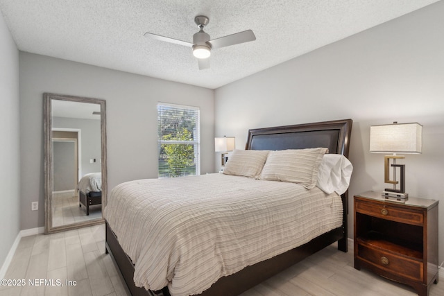 1254 Palisades Dr, Jacksonville, FL 32221 - bedroom featuring light wood-style floors, baseboards, a textured ceiling, and ceiling fan