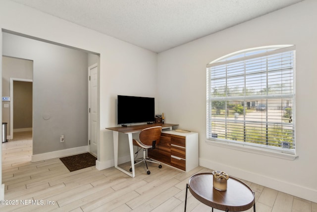 1254 Palisades Dr, Jacksonville, FL 32221 - office featuring baseboards, light wood-style flooring, and a textured ceiling