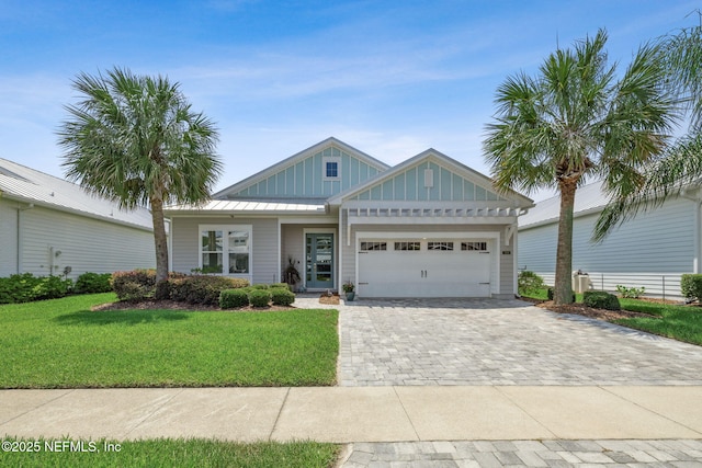 244 Caribbean Pl, Saint Johns, FL 32259 - view of front of property with board and batten siding, a garage, a front yard, and decorative driveway