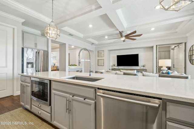 244 Caribbean Pl, Saint Johns, FL 32259 - kitchen featuring appliances with stainless steel finishes, a sink, open floor plan, wood finished floors, and ornamental molding