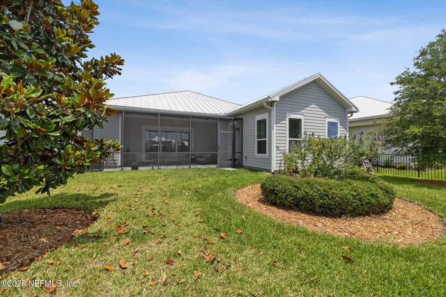 244 Caribbean Pl, Saint Johns, FL 32259 - rear view of house featuring a sunroom and metal roof