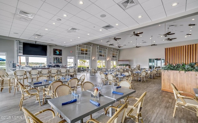 244 Caribbean Pl, Saint Johns, FL 32259 - dining space with a high ceiling, plenty of natural light, wood finished floors, a drop ceiling, and ceiling fan