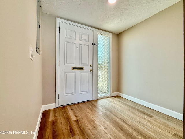 7779 Las Palmas Way Unit 114, Jacksonville, FL 32256 - entryway featuring light wood-style floors, baseboards, and a textured ceiling