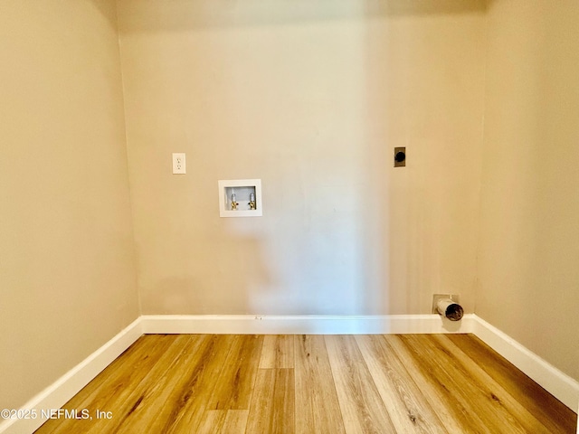 7779 Las Palmas Way Unit 114, Jacksonville, FL 32256 - washroom with hookup for an electric dryer, baseboards, hookup for a washing machine, and wood finished floors