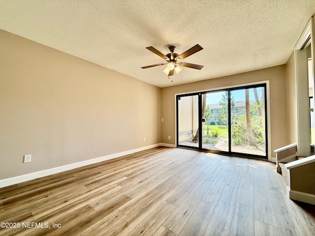 7779 Las Palmas Way Unit 114, Jacksonville, FL 32256 - empty room with wood finished floors, a textured ceiling, baseboards, and a ceiling fan