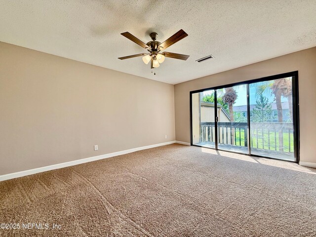 7779 Las Palmas Way Unit 114, Jacksonville, FL 32256 - spare room with ceiling fan, carpet, baseboards, and a textured ceiling