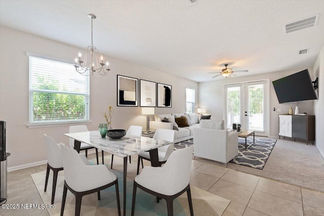 1011 Wetland Ridge Cir, Middleburg, FL 32068 - dining space with a chandelier, light tile patterned floors, a ceiling fan, a textured ceiling, and baseboards