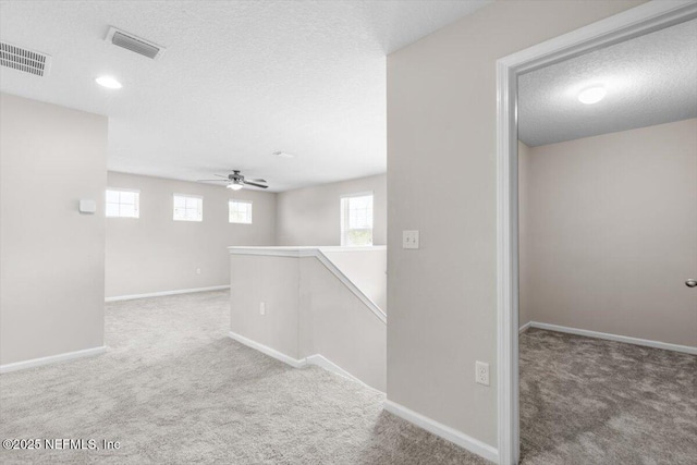 1011 Wetland Ridge Cir, Middleburg, FL 32068 - corridor with carpet floors, an upstairs landing, baseboards, and a textured ceiling