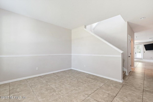 1011 Wetland Ridge Cir, Middleburg, FL 32068 - empty room featuring stairs, baseboards, and tile patterned floors