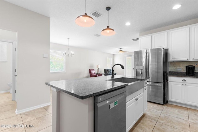 1011 Wetland Ridge Cir, Middleburg, FL 32068 - kitchen with dishwashing machine, stainless steel fridge with ice dispenser, white cabinets, an island with sink, and light tile patterned flooring