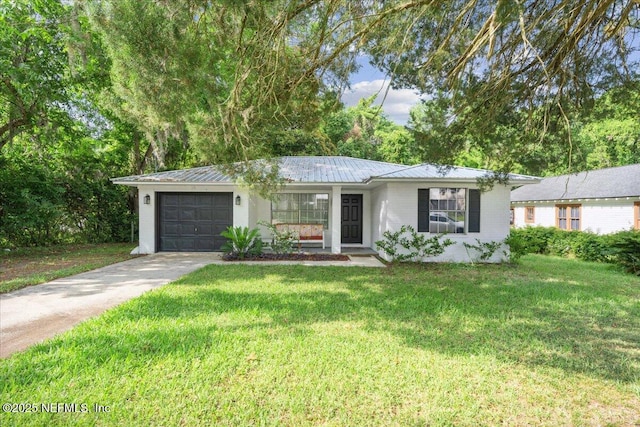 318 W Lafayette St, Starke, FL 32091 - ranch-style home with an attached garage, concrete driveway, a front lawn, and metal roof