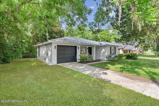 318 W Lafayette St, Starke, FL 32091 - ranch-style house with driveway, a garage, and metal roof