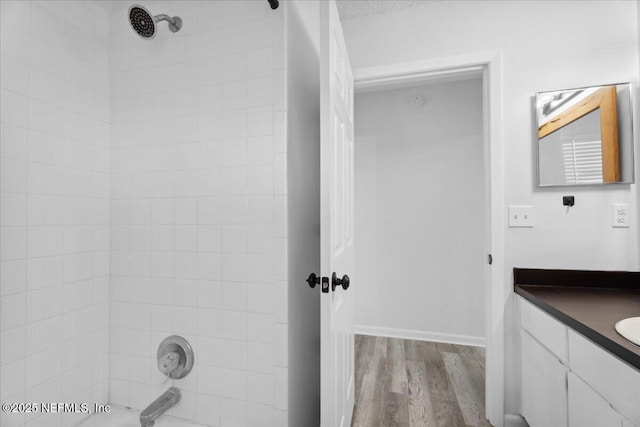 318 W Lafayette St, Starke, FL 32091 - bathroom featuring vanity, wood finished floors, and bathing tub / shower combination