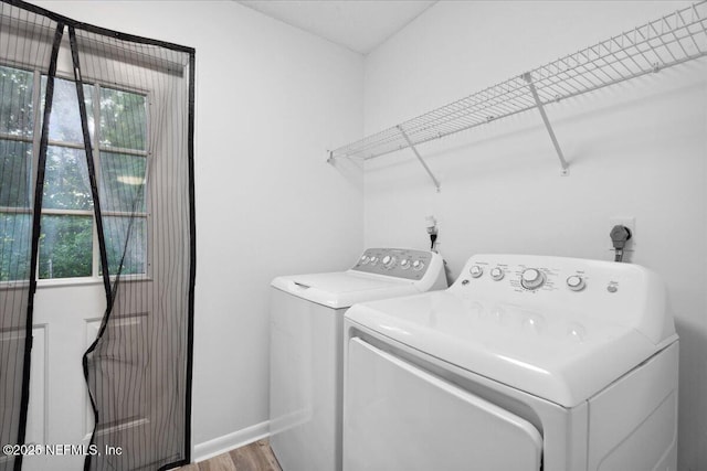 318 W Lafayette St, Starke, FL 32091 - laundry room with washing machine and dryer, plenty of natural light, wood finished floors, and baseboards
