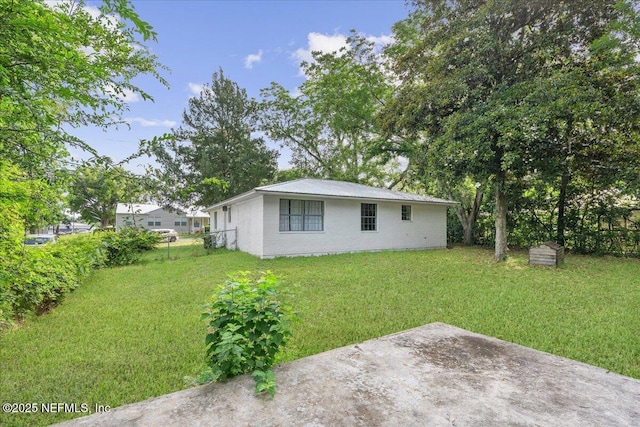 318 W Lafayette St, Starke, FL 32091 - rear view of property with a yard, a patio area, and brick siding