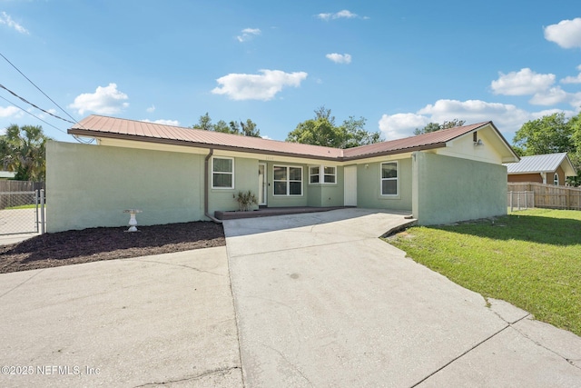 1515 Husson Ave, Palatka, FL 32177 - ranch-style house featuring metal roof, stucco siding, and concrete driveway
