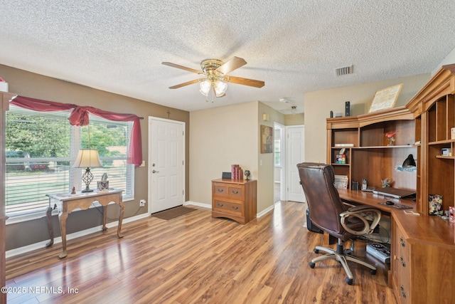1515 Husson Ave, Palatka, FL 32177 - office area with light wood-style floors, ceiling fan, a textured ceiling, and baseboards