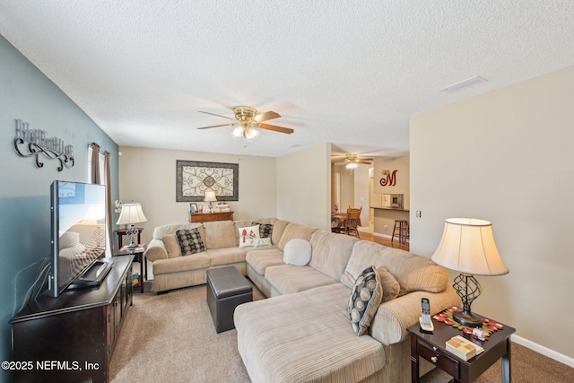 1515 Husson Ave, Palatka, FL 32177 - living area featuring ceiling fan, carpet flooring, a textured ceiling, and baseboards