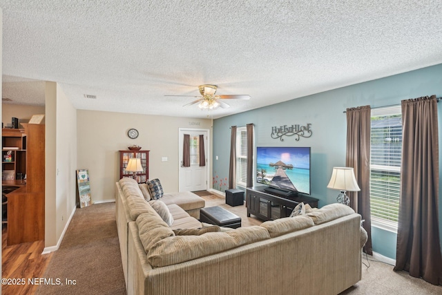 1515 Husson Ave, Palatka, FL 32177 - living area featuring a ceiling fan, baseboards, carpet, and a textured ceiling