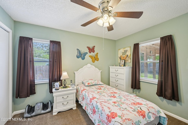 1515 Husson Ave, Palatka, FL 32177 - bedroom featuring dark colored carpet, multiple windows, ceiling fan, baseboards, and a textured ceiling