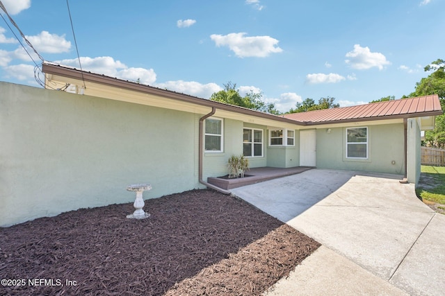 1515 Husson Ave, Palatka, FL 32177 - property entrance with stucco siding, a patio area, and metal roof
