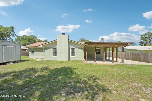 1515 Husson Ave, Palatka, FL 32177 - back of house featuring a patio area, a chimney, and stucco siding
