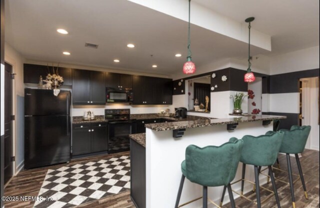 945 Registry Blvd Unit 207, Saint Augustine, FL 32092 - kitchen featuring black appliances, dark stone countertops, recessed lighting, a breakfast bar area, and pendant lighting