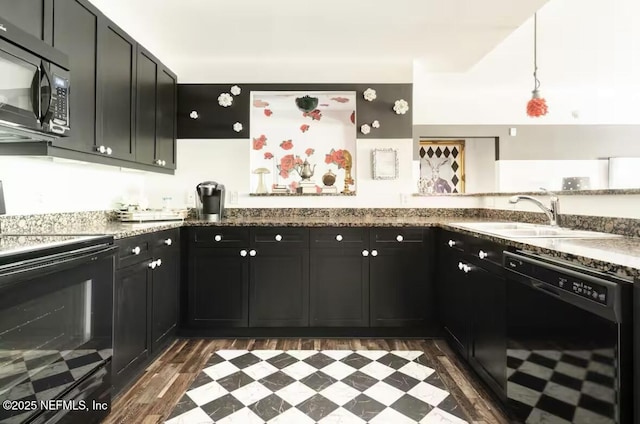 945 Registry Blvd Unit 207, Saint Augustine, FL 32092 - kitchen featuring black appliances, a sink, dark cabinetry, dark floors, and stone countertops